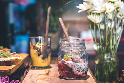 Slice Fruit in Clear Glass Jar Above Brown Wooden Table, blurred background HD wallpaper