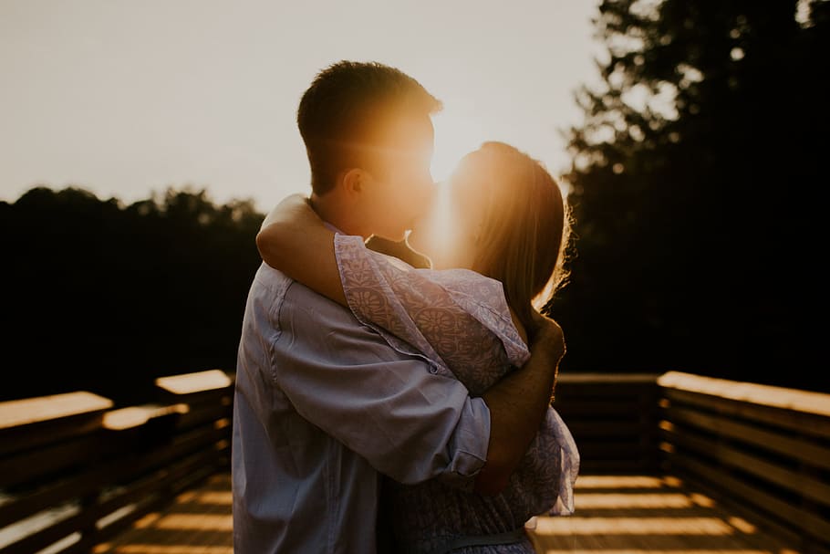man and woman kissing during sunset, sunrise, together, love