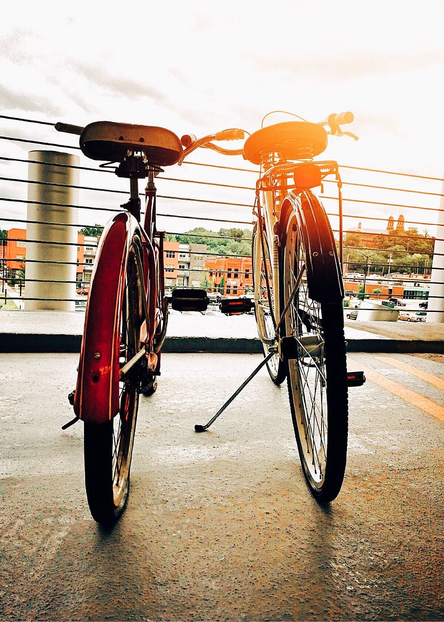 Two Bicycles Parked Upright, action, biking, blur, city, couple HD wallpaper