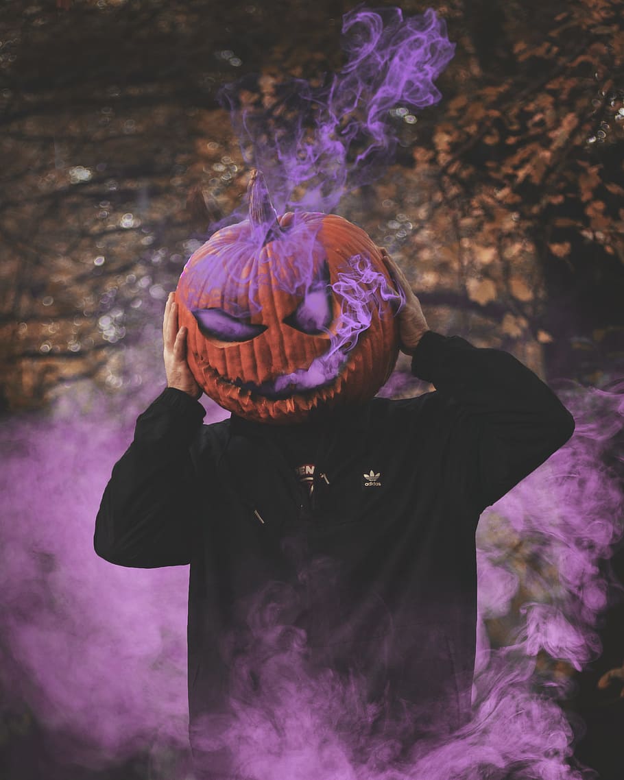 man wearing jack-o-lantern, pumpkin, smoke, carve, carving, scary