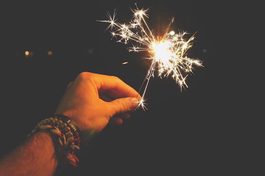 Photo of Person Holding Sparkler, bracelets, celebration, close-up HD wallpaper