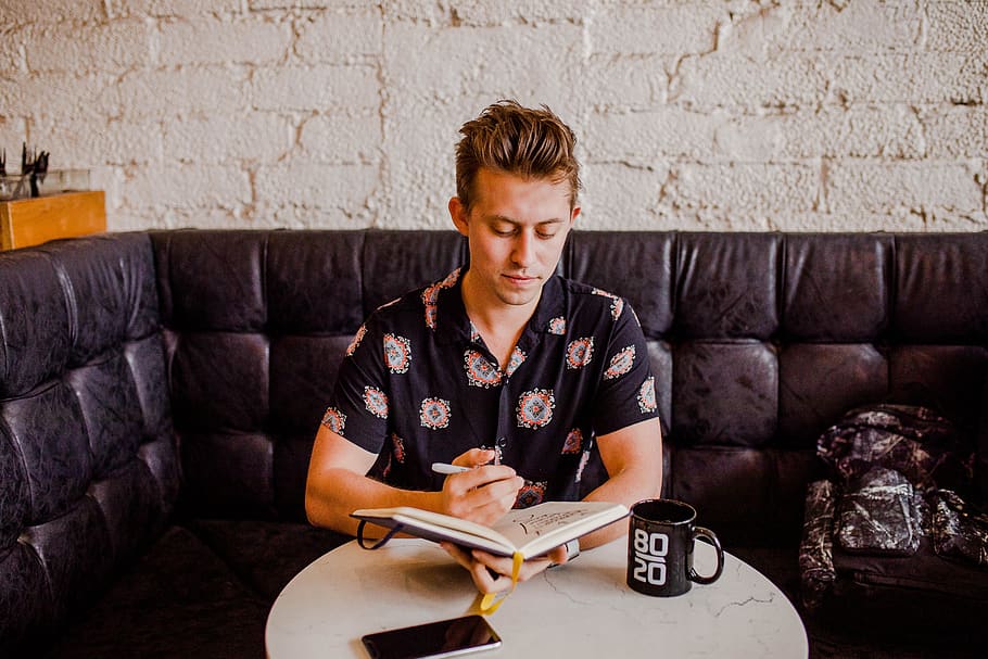 man sitting while holding an open book, furniture, couch, person HD wallpaper
