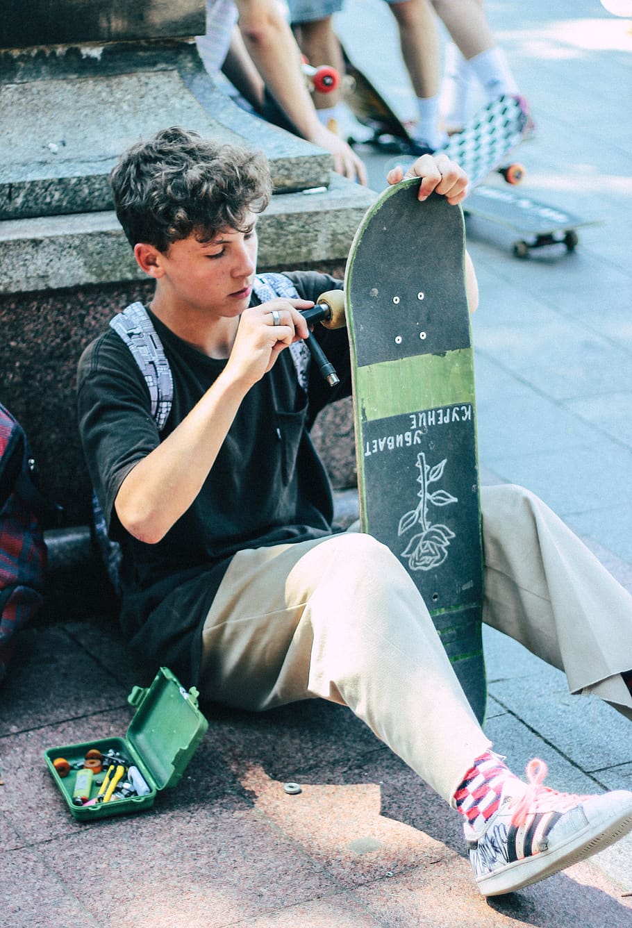man fixing his skateboard, real people, men, sitting, lifestyles HD wallpaper