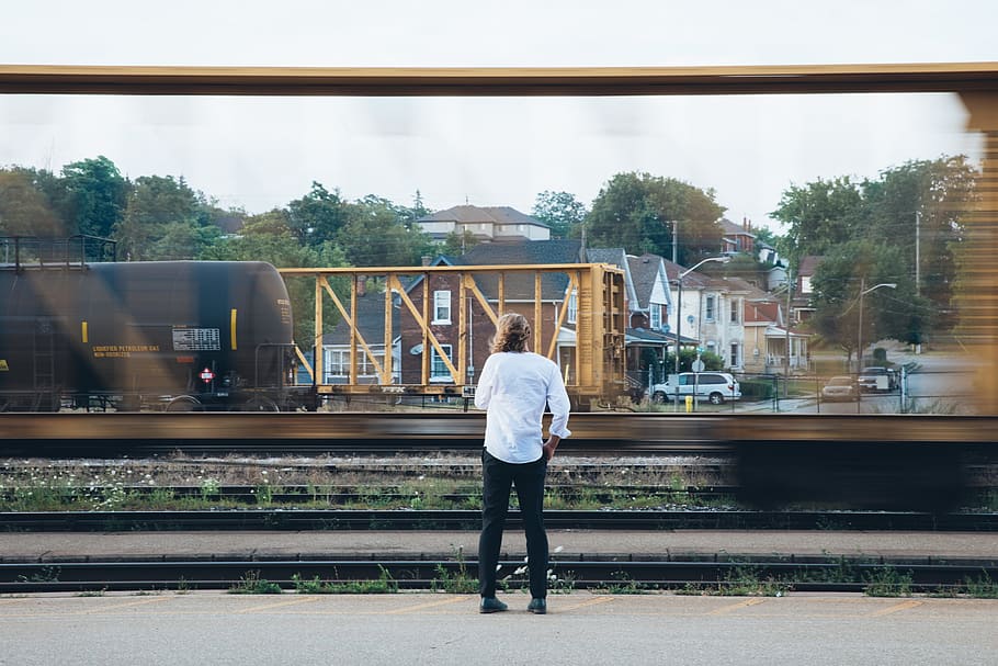 A long haired young caucasian man standing near passing train, HD wallpaper