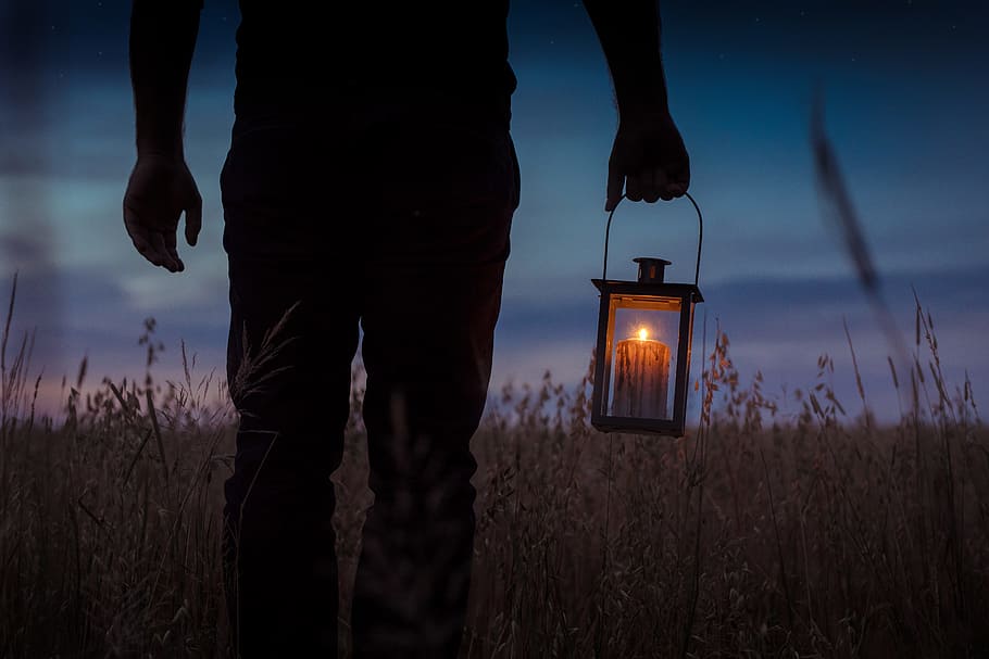 silhouette photo of man carrying candle lantern with lighted candle, HD wallpaper