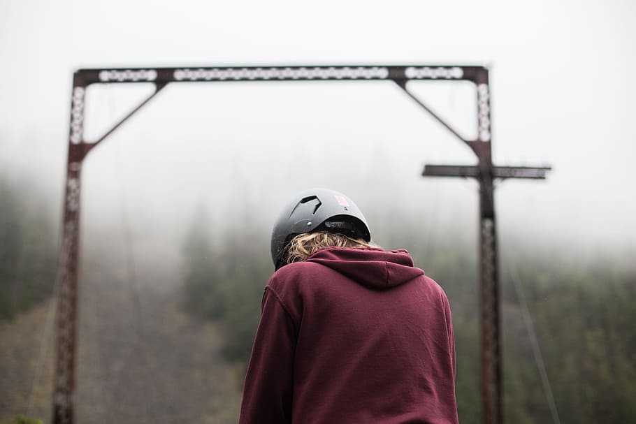 person wearing maroon hoodie, structure, helmet, mist, fog, path HD wallpaper