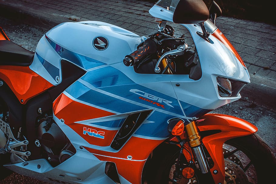 white-blue-and-orange Honda CBR sports bike, motorcycle, transportation