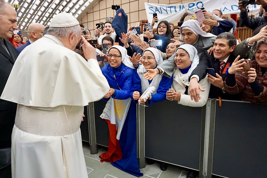 Pope Francis standing surrounded with people, human, person, crowd