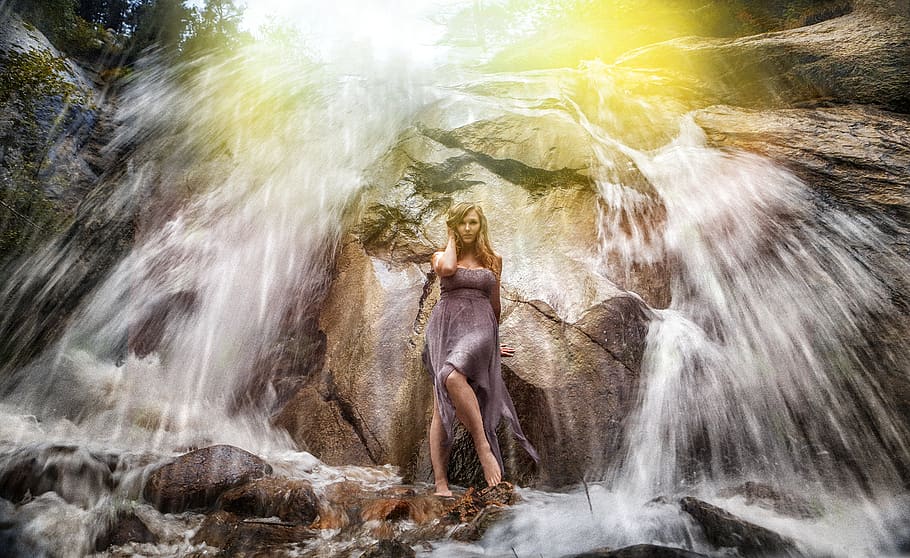 Woman in Gray Strapless Long Dress Standing Under Waterfalls HD wallpaper