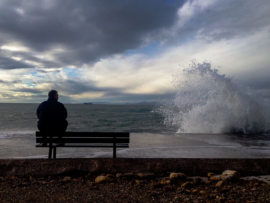 man, sea, wave, bench, landscape, wind, water, sky, seat, cloud - sky HD wallpaper