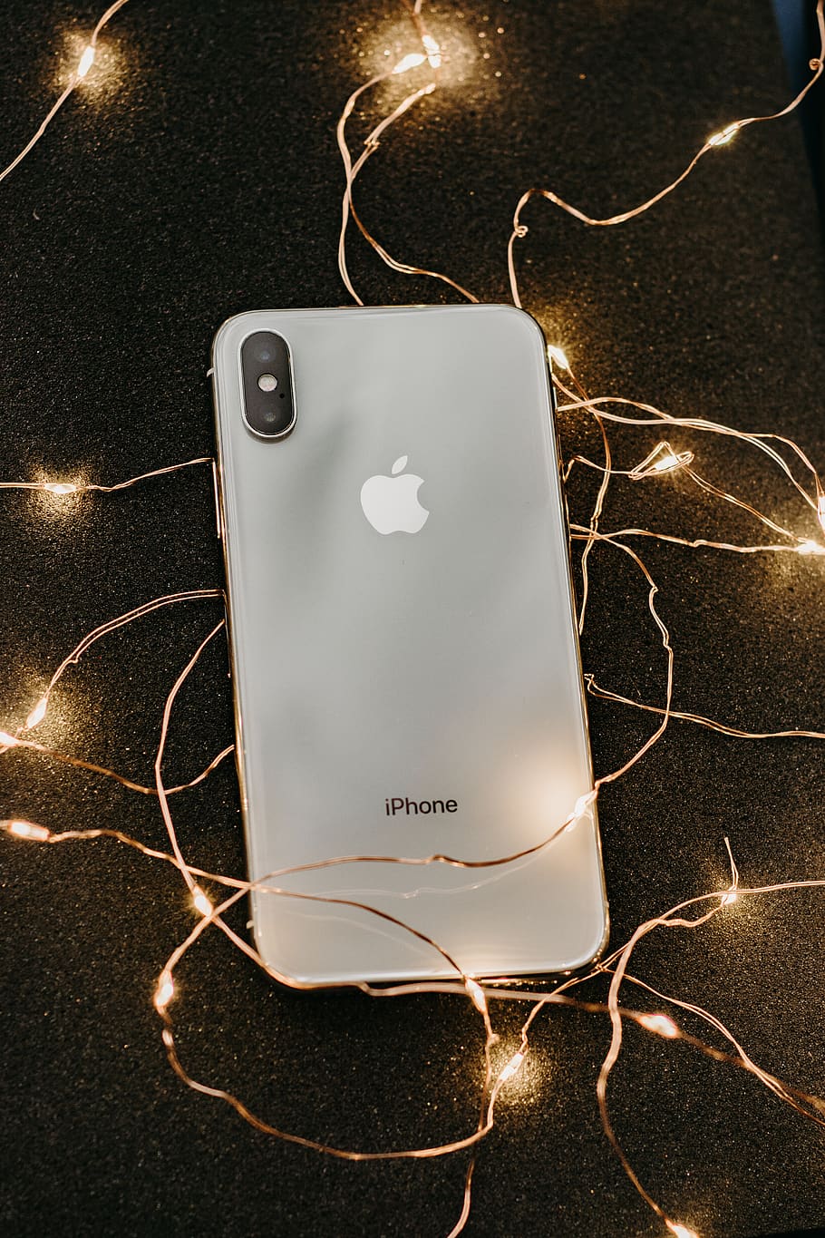 HD wallpaper: Silver Iphone X Lying on Pre-lit String Lights, communication  device | Wallpaper Flare
