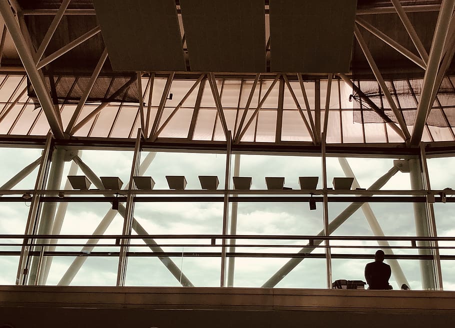 Silhouette of Person Sitting Inside Building, airport, architecture HD wallpaper