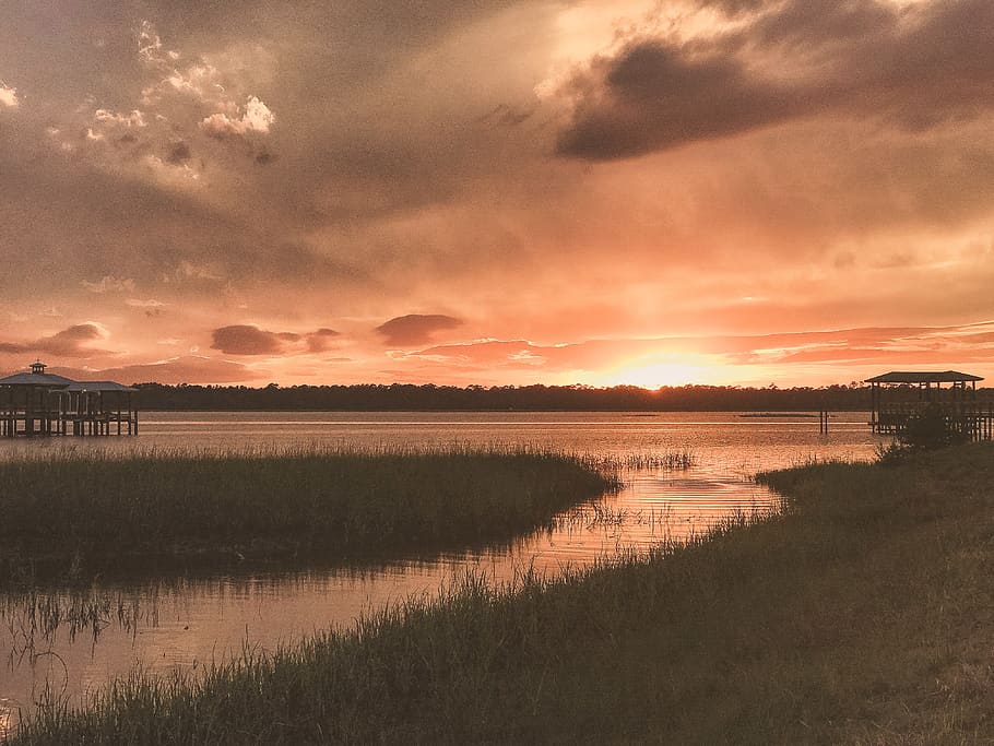 Grass Field Beside Body of Water during Sunset, clouds, evening HD wallpaper