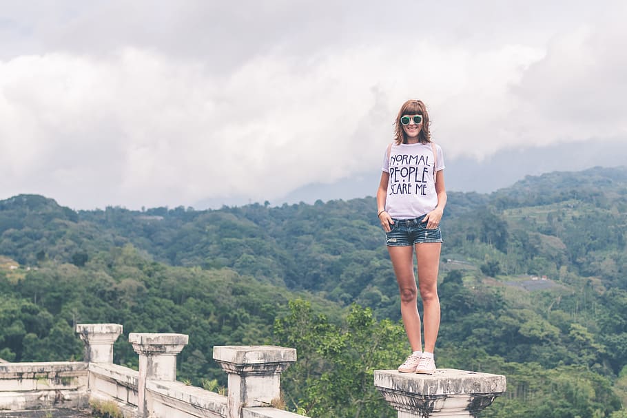 Woman Wearing White Shirt and Blue Denim Shorts Standing on Gray Concrete Stand HD wallpaper