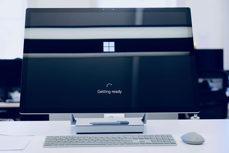 flat screen computer monitor turned on, keyboard, mouse, minimal
