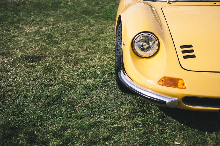 yellow car showing headlight, mode of transportation, grass, plant HD wallpaper
