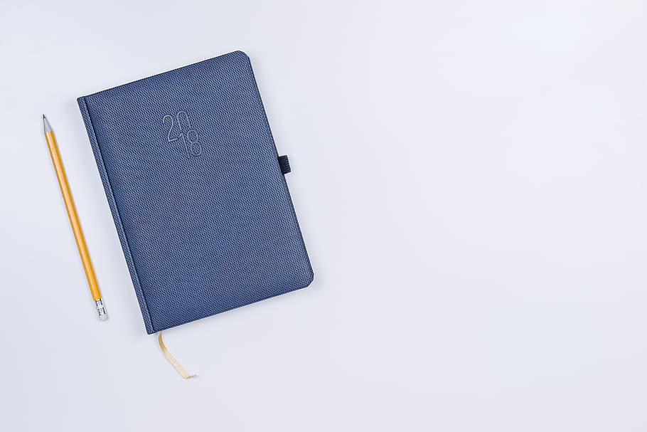 Pretty diary with a pencil on the white table., copy space, white background HD wallpaper