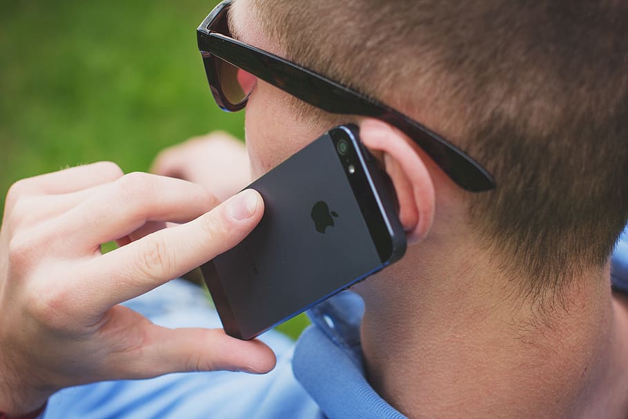 Man Putting His Black Iphone 5 on His Left Ear, apple, communication
