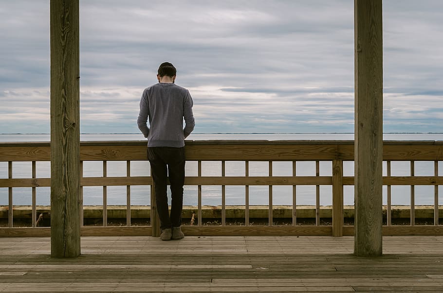 Man Standing at Front of Wooden Fence, beach, cloudy, daylight HD wallpaper