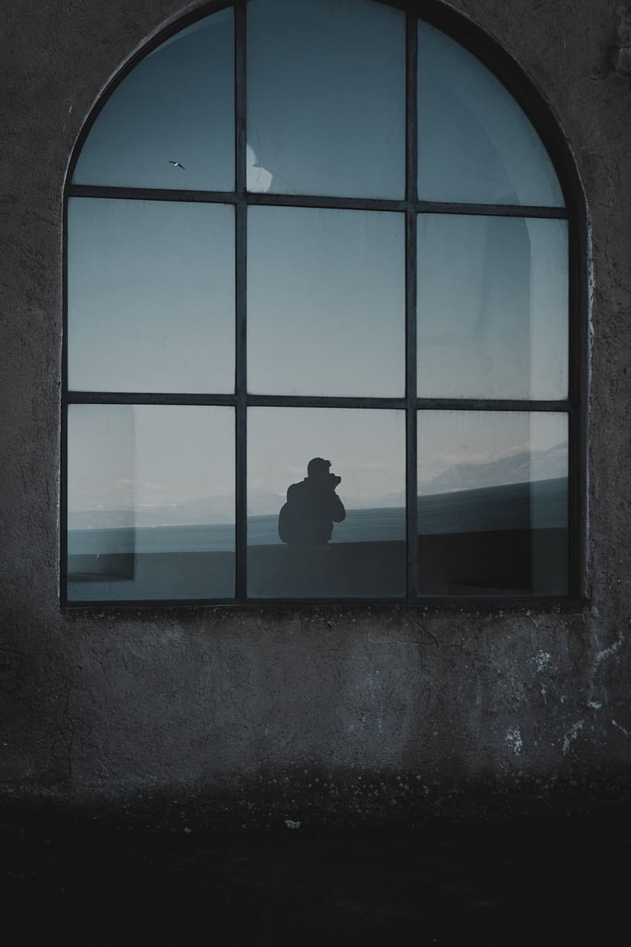 Silhouette Photo of Man Standing Beside Window, glass, glass windows