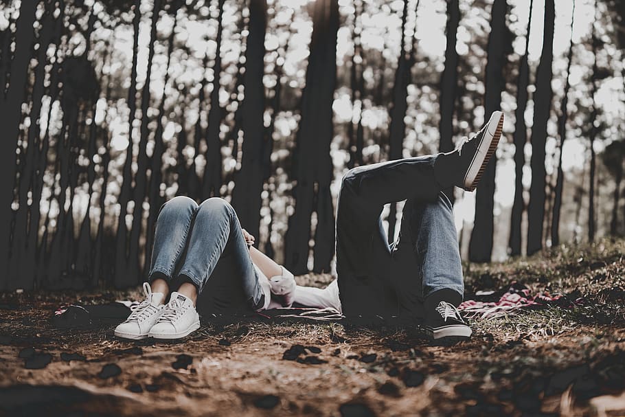 two person lying surrounded by trees, land, forest, real people HD wallpaper