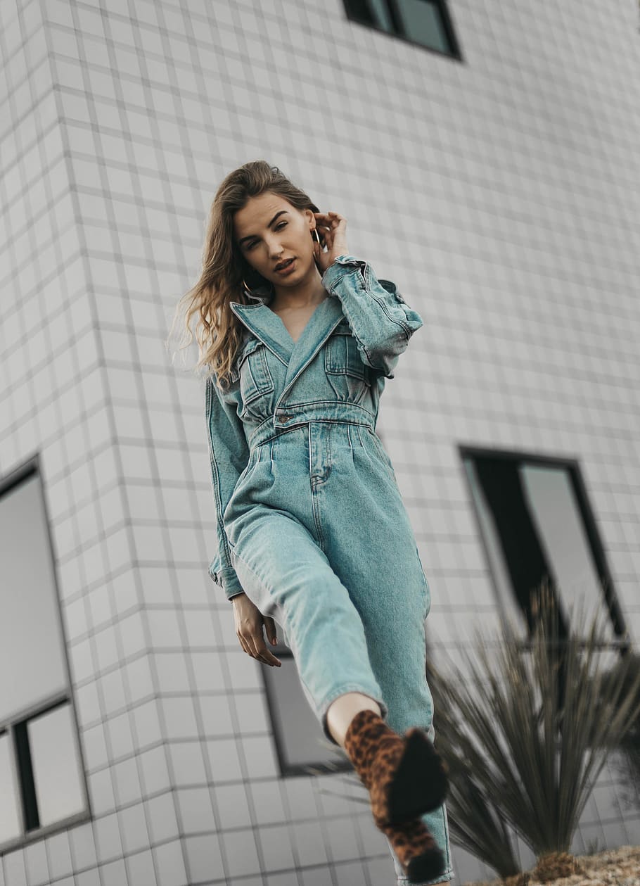 woman wearing blue denim overalls, pants, clothing, apparel, sleeve