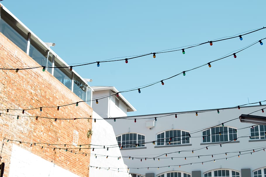 string lights near building during daytime, apartment building HD wallpaper