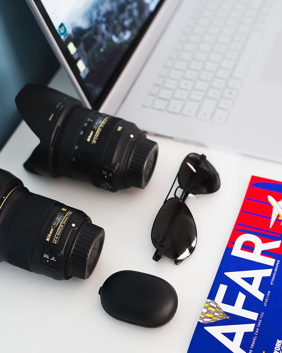 two black zoom lenses, black sunglasses, and black case beside white laptop computer, HD wallpaper