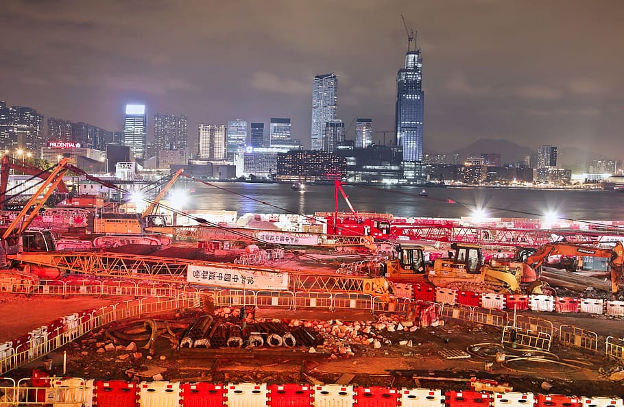 Night View Of Under Construction Building Site With Cranes In Hong Kong