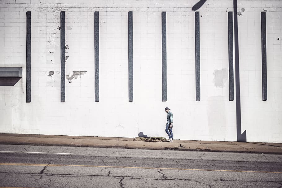 man walking at the side of the road beside wall, human, person, HD wallpaper