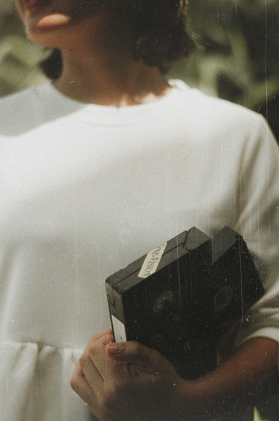 Woman Holding Black Vhs Tape, person, tapes, vhs tapes, one person
