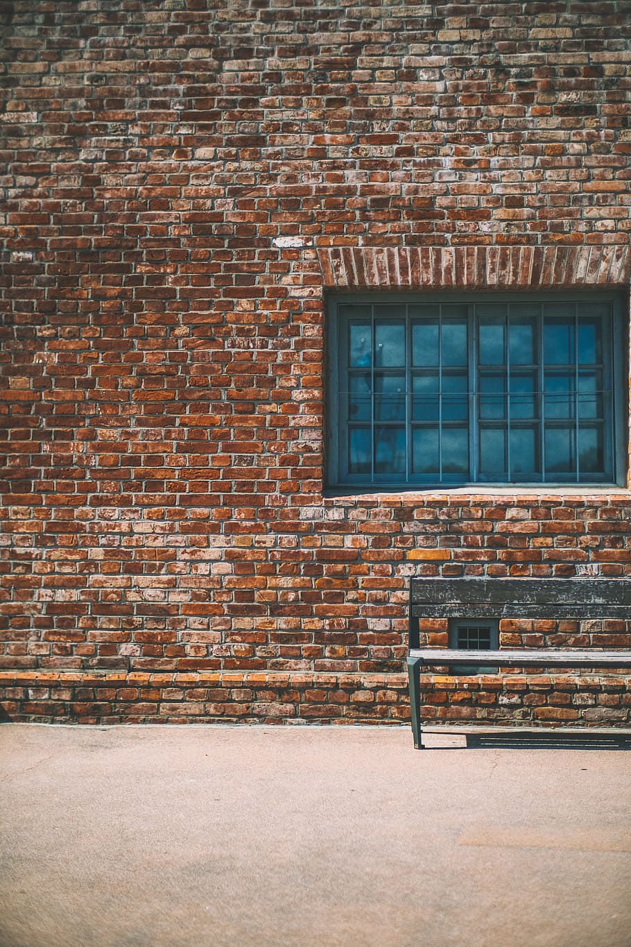 gray bench beside brown brick wall, building, window, seat, outdoors