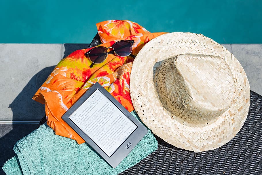 Black Amazon Kindle Tablet Near Brown Drawstring Sun Hat, flat lay HD wallpaper