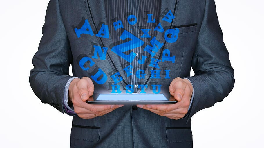 Letters pouring from a handheld tablet device. Ebook concept. HD wallpaper