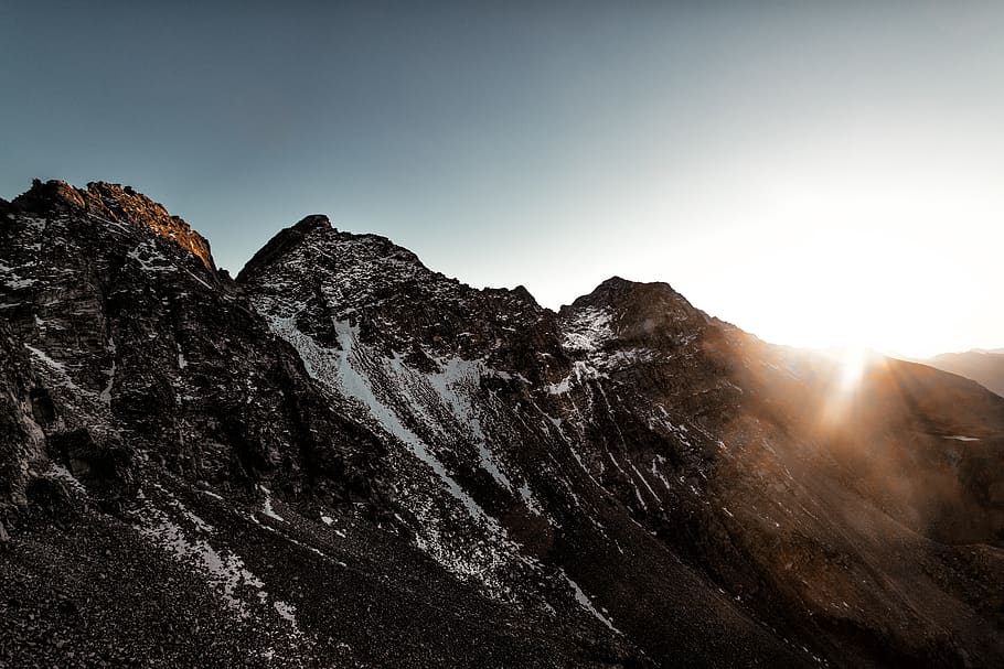 Gray Rock Mountain With White Snow during Sun Rise Aerial Photography HD wallpaper