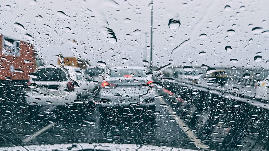 rain drops on clear glass windshield, traffic, wet windshield