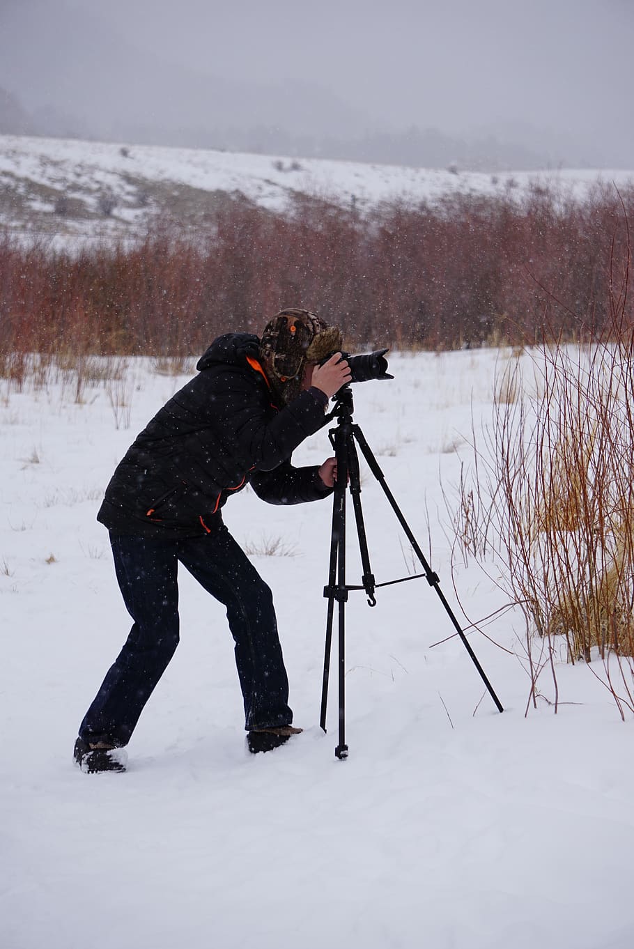Man Taking Photo in the Middle of Snow-covered Ground, action HD wallpaper