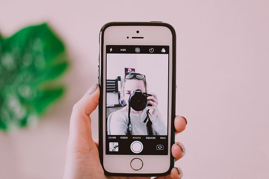 Person Holding Iphone , camera, device, electronics, screen, selfie HD wallpaper