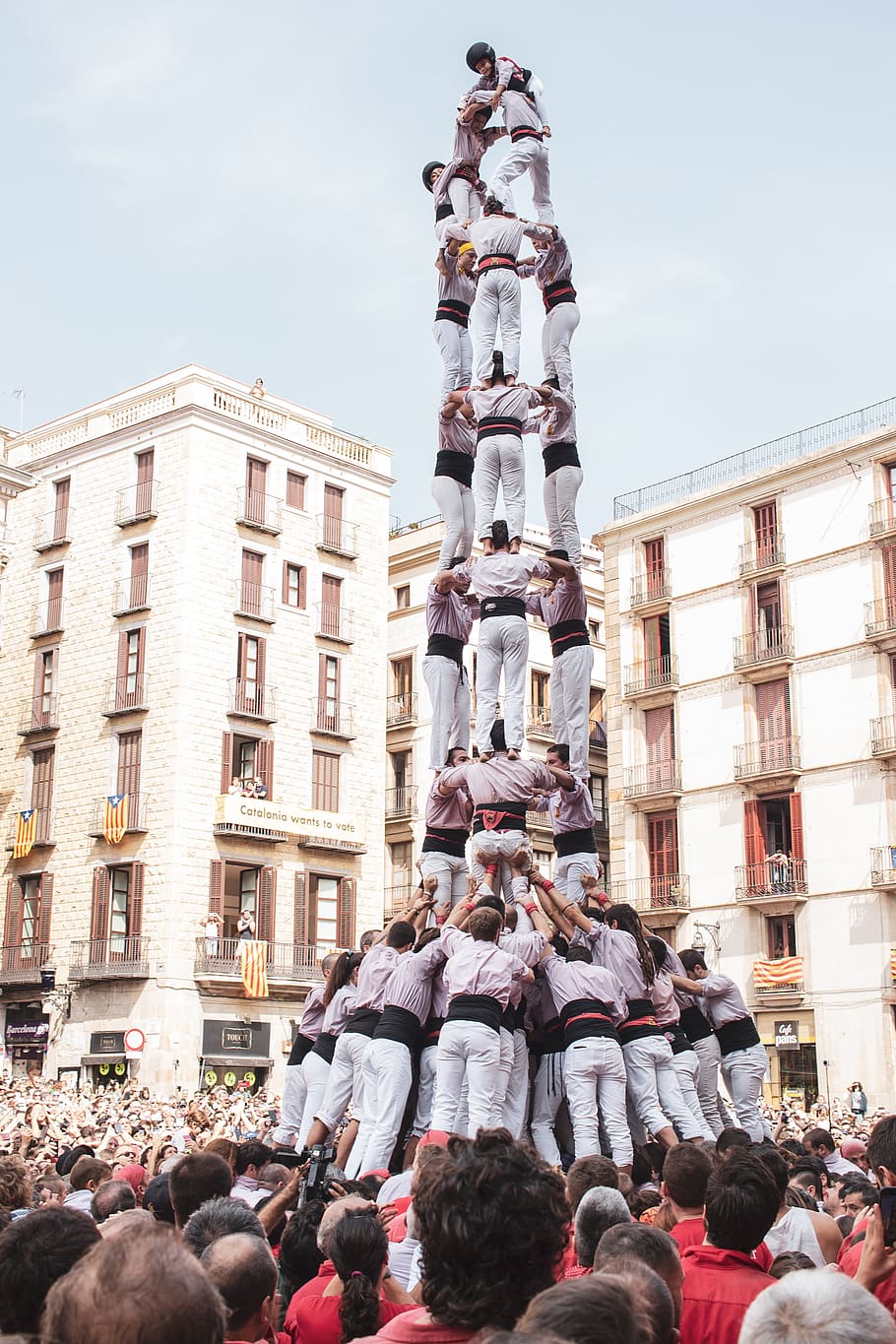 human tower event, city, downtown, urban, building, person, barcelona