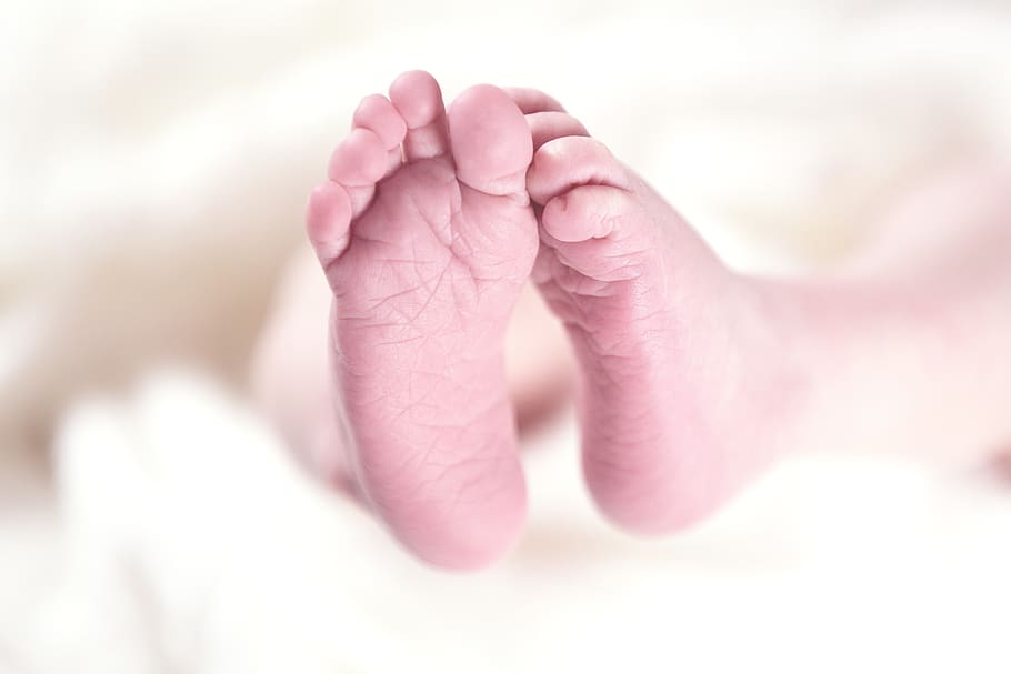 Baby's Foot on White Textile, baby feet, macro, tiny, human body part, HD wallpaper