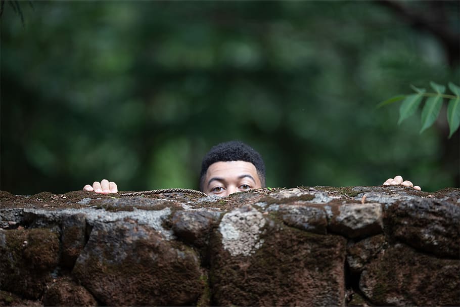 man behind \brown rock, one person, headshot, real people, solid HD wallpaper