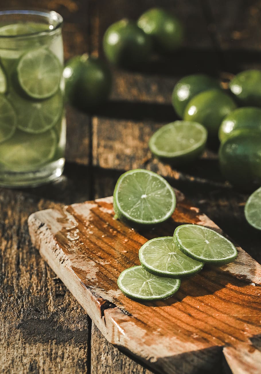 Slice of Limes on Brown Wood Chopper, close-up, color, drink, HD wallpaper