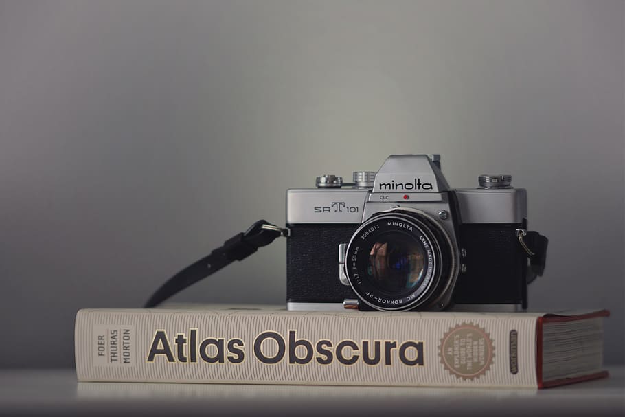 gray Minolta camera on book, technology, text, photography themes HD wallpaper