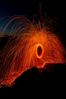 person taking photo of round steel wool, spark, circle, spinning HD wallpaper