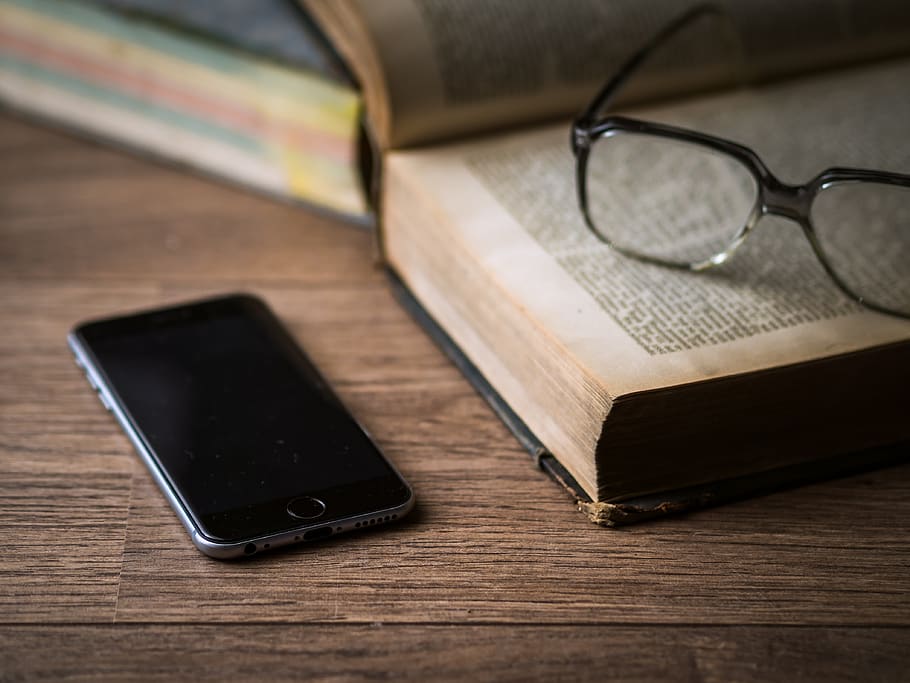 Space Gray Iphone 6 on Top of Brown Table Beside Book, desk, eyeglasses HD wallpaper