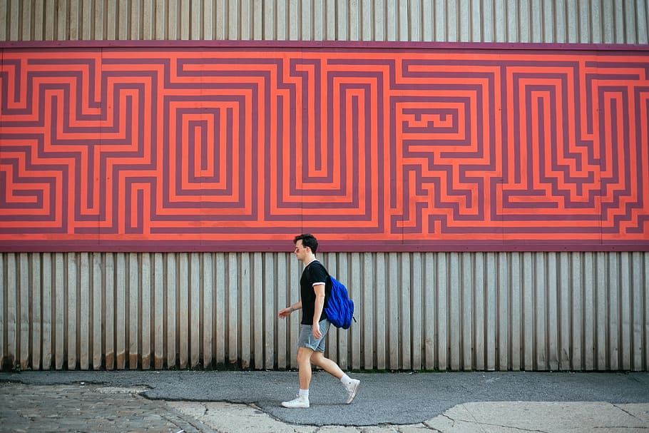 man carrying blue backpack walking along pathway, human, person HD wallpaper