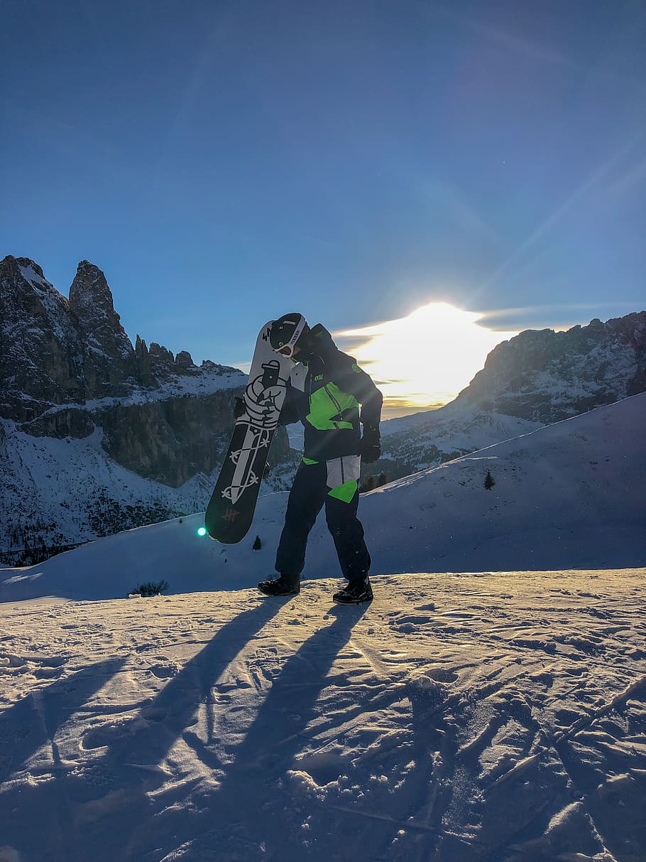 Mountain active. Man holding Snowboard.