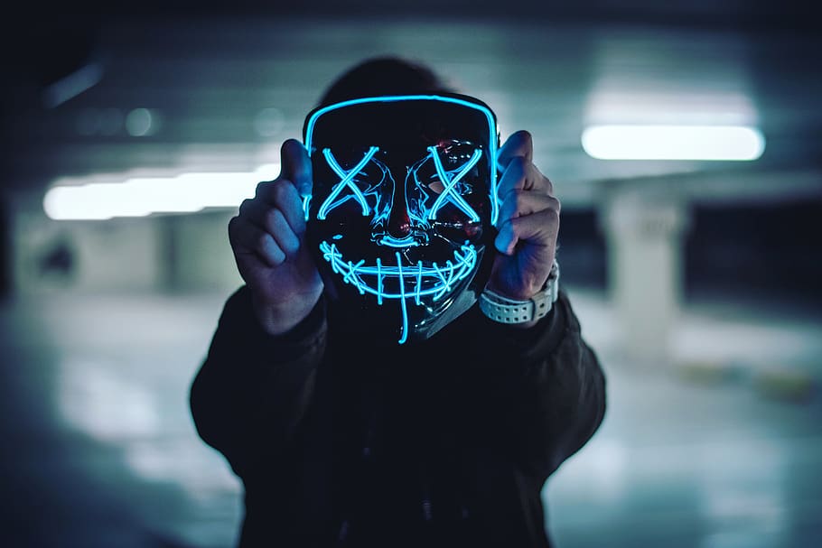 man holding full-face mask, real people, focus on foreground HD wallpaper