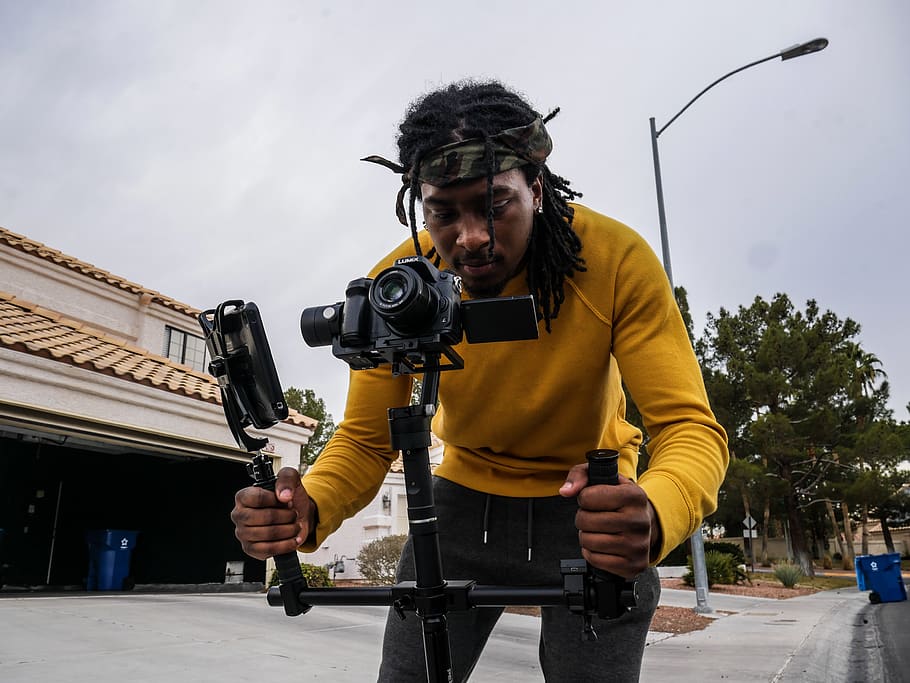 Man Wearing Yellow Long-sleeved Shirt Holding Camera Stand, cellphone HD wallpaper