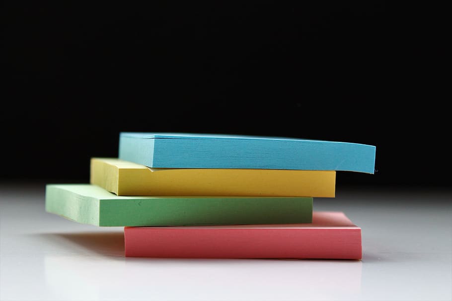 four assorted-color sticky notes, book, novel, text, homework